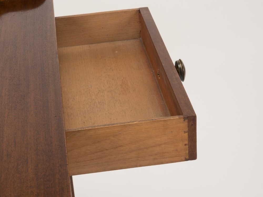 An early 19th-century mahogany tray-top writing table featuring a gallery edge with side cutout handles, two drawers with knob handles, and square tapered legs. View XI