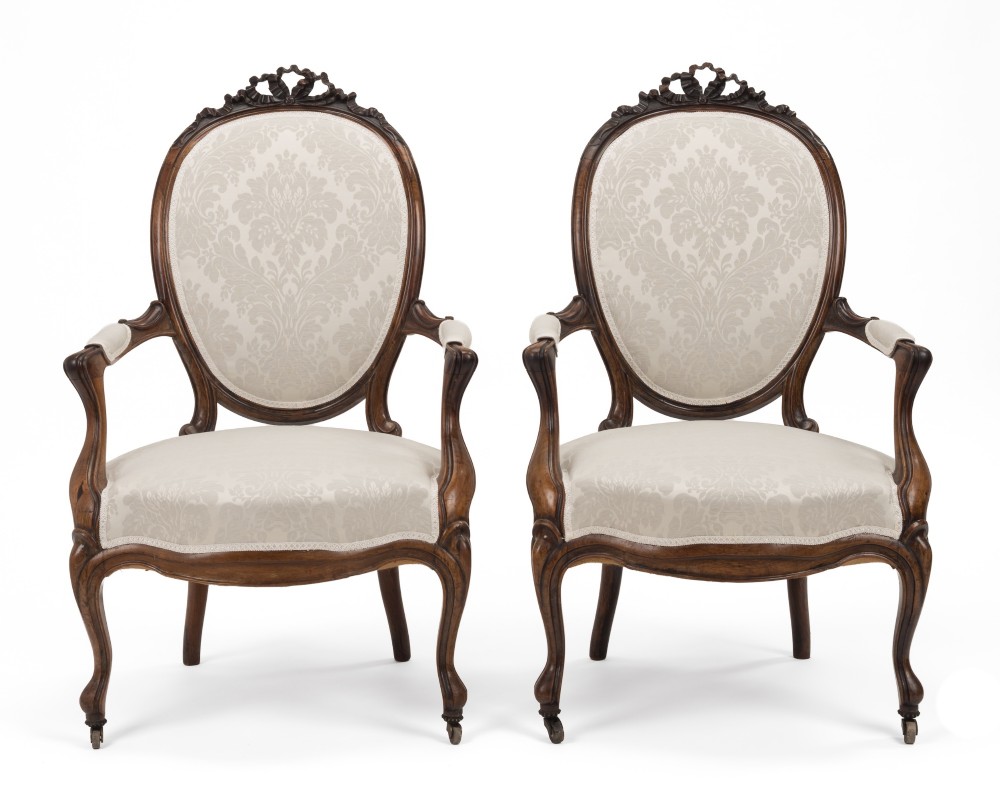 A pair of mid-19th century English rosewood Rococo Revival open armchairs with oval damask backs, carved top crests, padded arms, and cabriole legs on castors. View IX