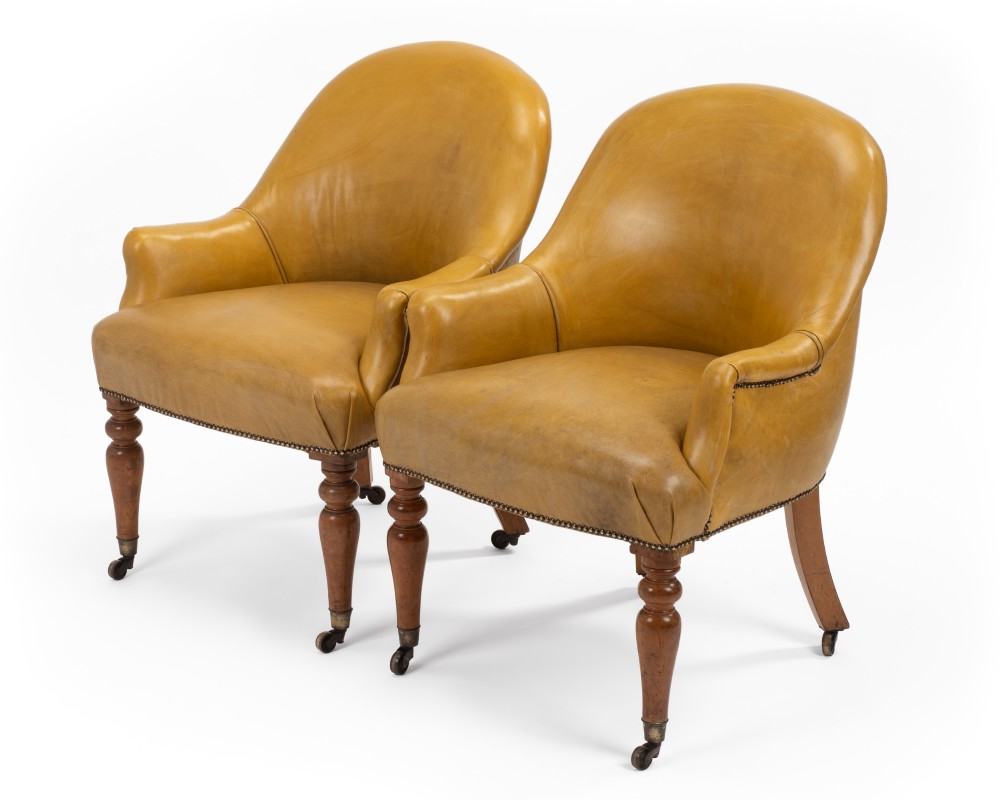 A pair of early 19th-century Regency library armchairs upholstered in warm tan leather with turned maple front legs on brass castors. View III