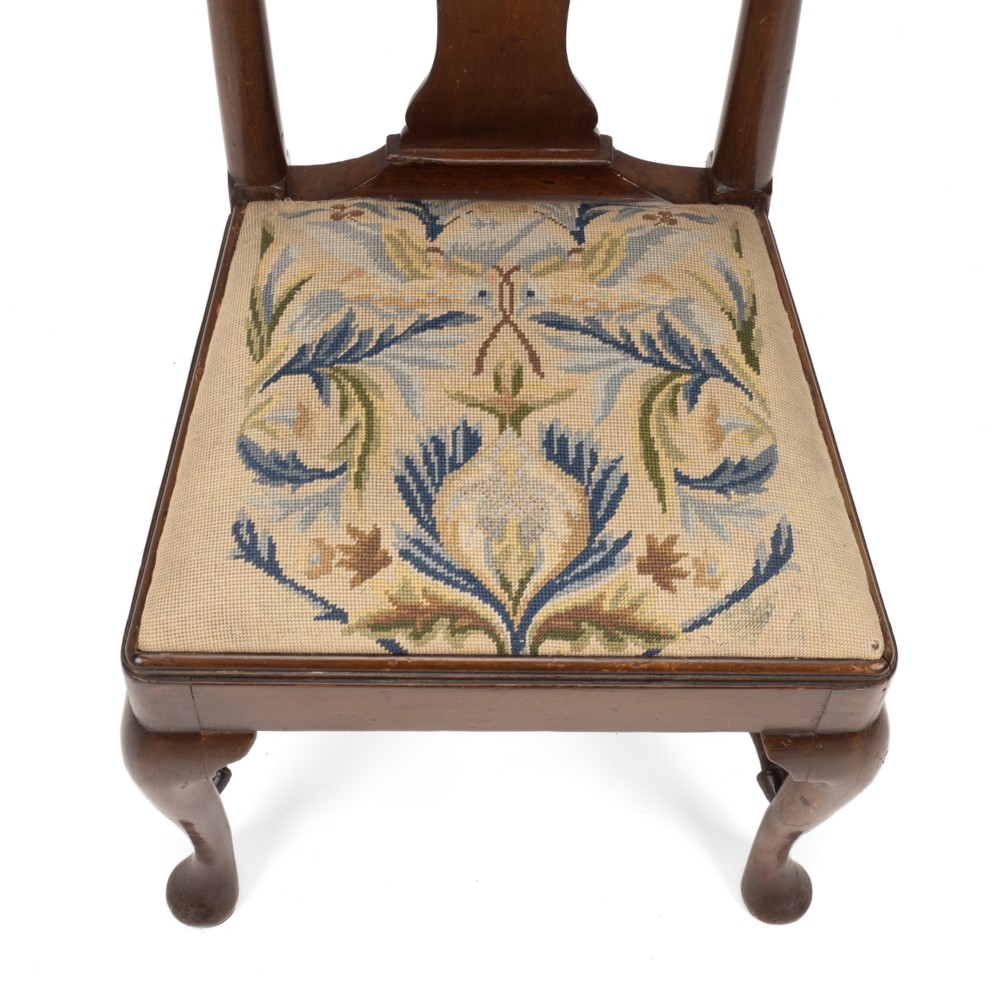 A George II walnut side chair featuring a shaped vasiform splat, cabriole front legs with pad feet, turned stretchers, and a floral needlework drop-in seat. View III