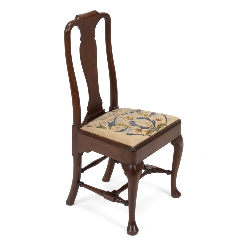 A George II walnut side chair featuring a shaped vasiform splat, cabriole front legs with pad feet, turned stretchers, and a floral needlework drop-in seat. View IV