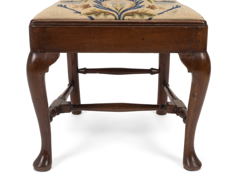 A George II walnut side chair featuring a shaped vasiform splat, cabriole front legs with pad feet, turned stretchers, and a floral needlework drop-in seat. View VI