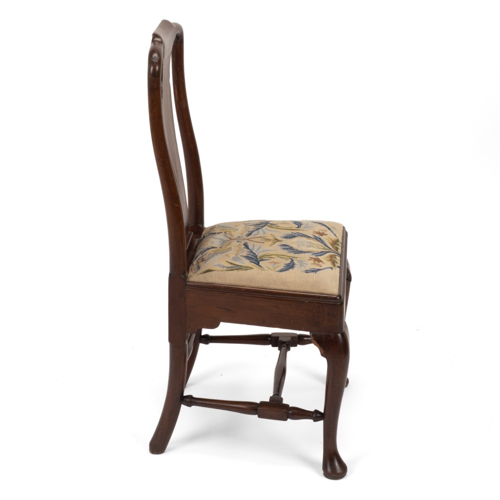 A George II walnut side chair featuring a shaped vasiform splat, cabriole front legs with pad feet, turned stretchers, and a floral needlework drop-in seat. View VIII