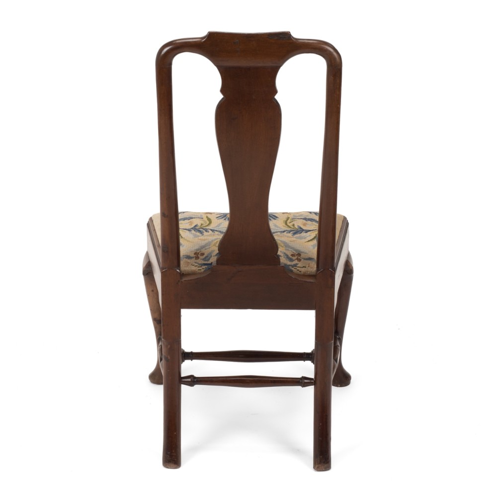 A George II walnut side chair featuring a shaped vasiform splat, cabriole front legs with pad feet, turned stretchers, and a floral needlework drop-in seat. View IX