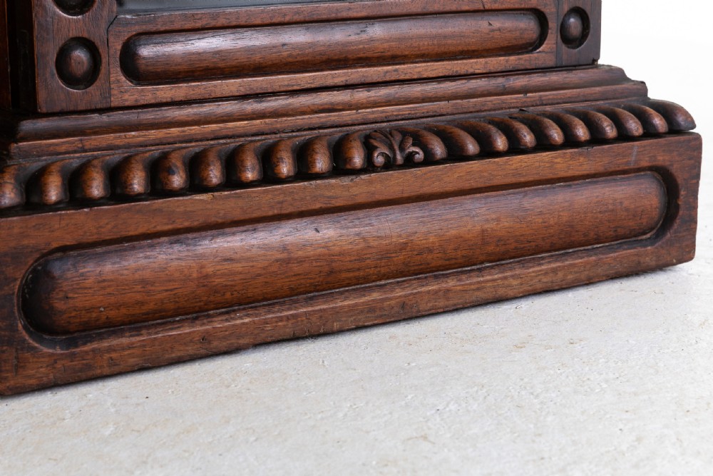 A nineteenth-century Anglo-Indian breakfront bookcase made of dark padouk wood with four glazed doors and carved upper mouldings. View V