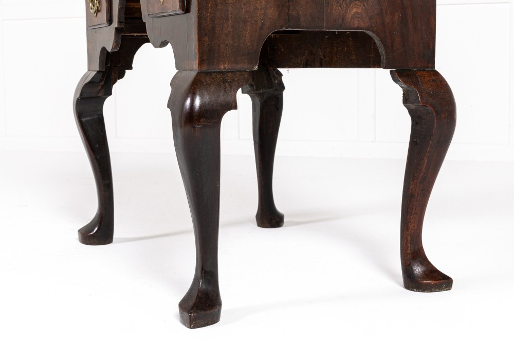 A George II mahogany lowboy featuring three drawers, brass backplate handles, a shaped apron, and four cabriole legs with pad feet. View VII