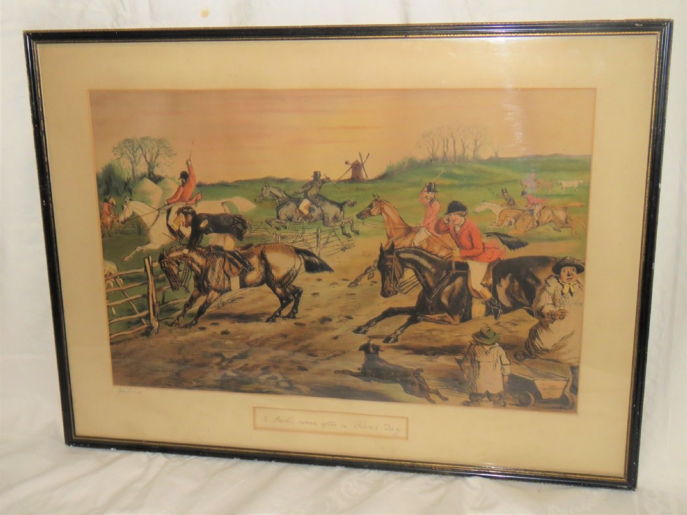 A framed Victorian sporting print depicting equestrian riders and foxhounds in a rural landscape with a windmill in the background, set within a cream mount and black wooden frame.