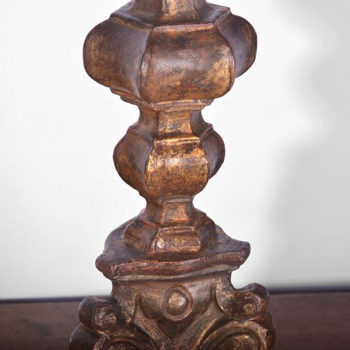 fig 1. An 18th-century carved giltwood altar candlestick converted into a tall table lamp with a flared dark lampshade.