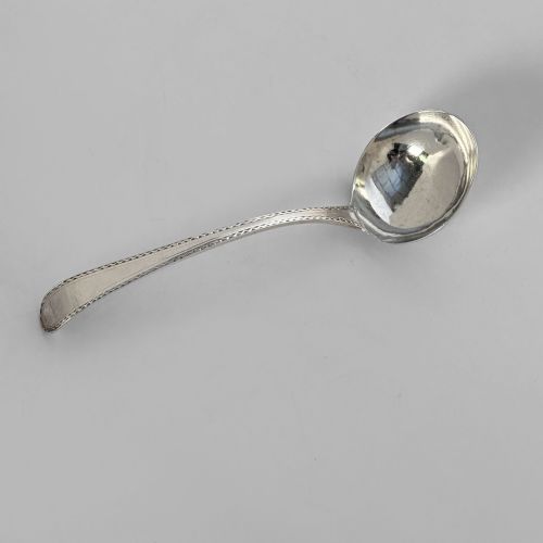 fig 1. A pair of Georgian sterling silver sauce ladles with circular bowls and beaded edge decoration along the handles.
