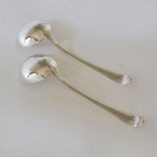 fig 2. A pair of Georgian sterling silver sauce ladles with circular bowls and beaded edge decoration along the handles.