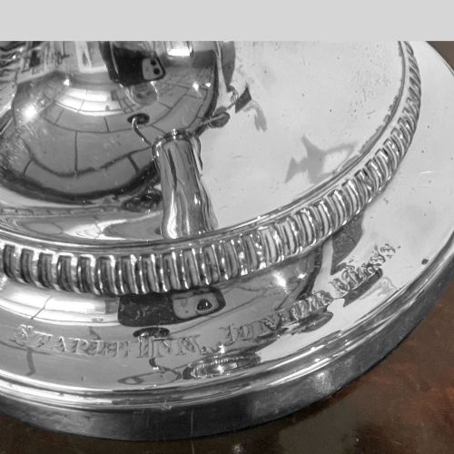 fig 1. A silver-plated Regency three-light candelabrum featuring reeded curved branches, beaded rims, and a tapered central column resting on a circular stepped base.