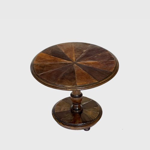 fig 1. A 19th-century miniature circular tilt-top pedestal table featuring a radiating segmented parquetry pattern in varied wood veneers set upon a turned base.