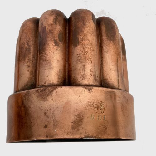 fig 1. A nineteenth-century circular copper jelly mould featuring a fluted lobed upper design above a smooth cylindrical rim.