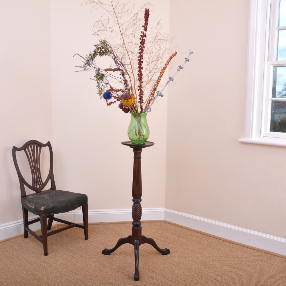 An antique mahogany torchere stand featuring a dished circular top, a reeded and spiral-carved central column, and a tripod base. View VIII
