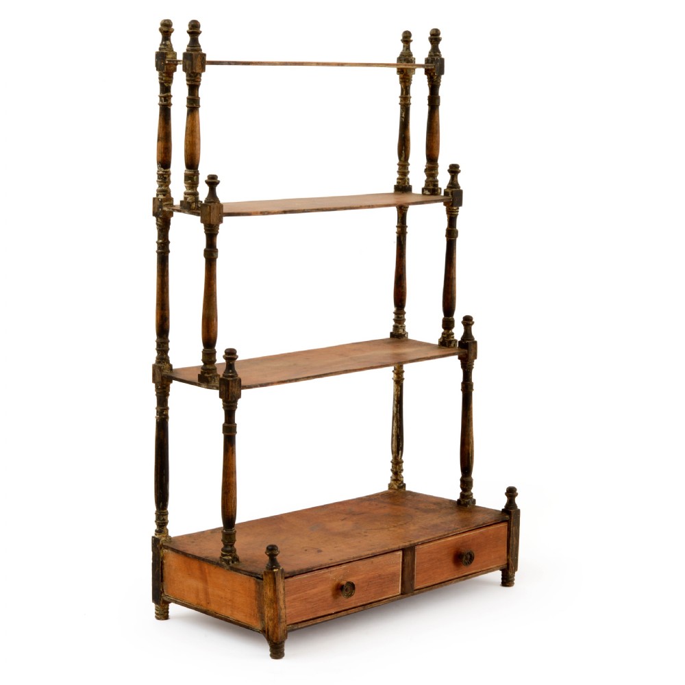 A Regency mahogany tabletop shelving unit with three graduated open tiers supported by turned spindles over a base with two drawers. View II