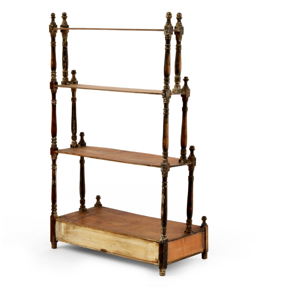 A Regency mahogany tabletop shelving unit with three graduated open tiers supported by turned spindles over a base with two drawers. View VI