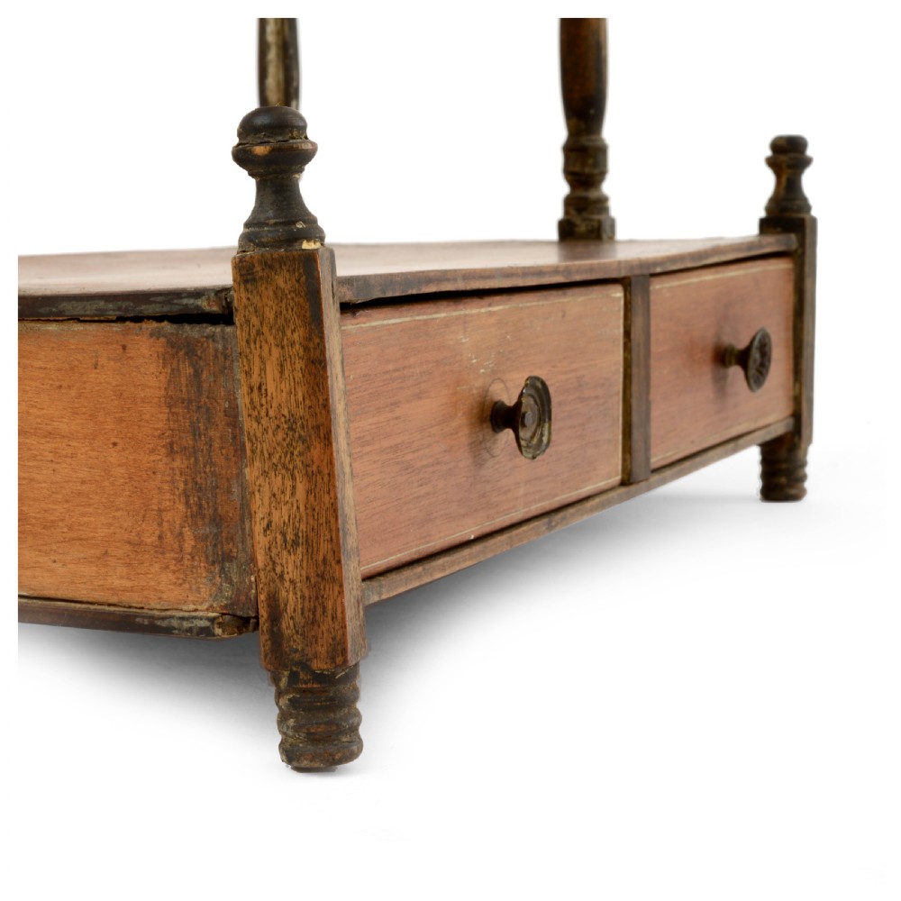 A Regency mahogany tabletop shelving unit with three graduated open tiers supported by turned spindles over a base with two drawers. View VII