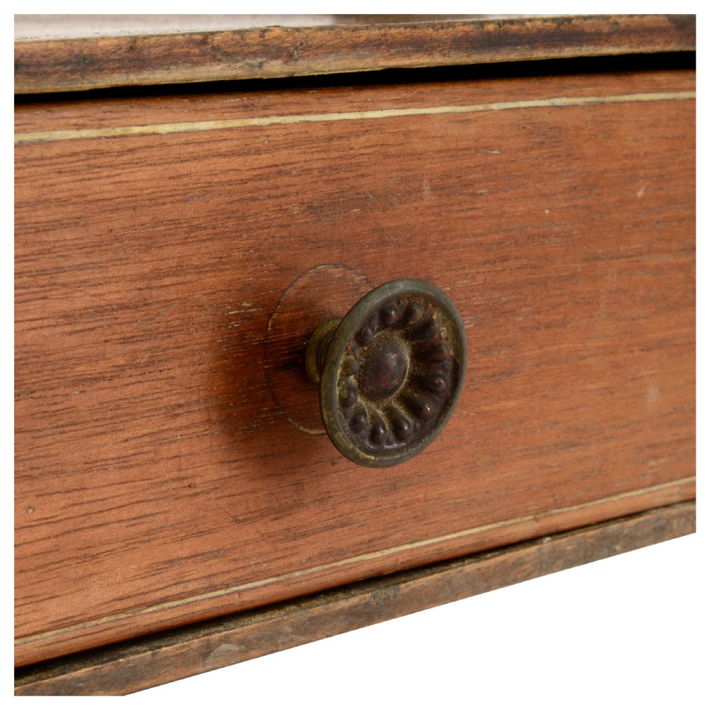 A Regency mahogany tabletop shelving unit with three graduated open tiers supported by turned spindles over a base with two drawers. View XII