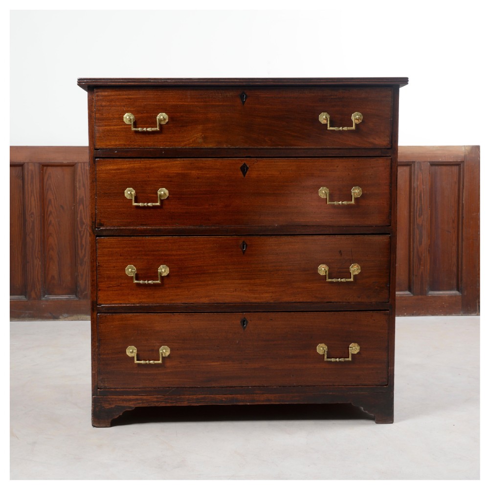 An Anglo-Indian padauk wood chest of drawers featuring four graduated drawers with brass bail handles and bracket feet. View IX