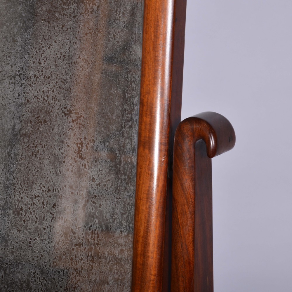 An antique mahogany dressing table mirror featuring a rectangular swivelling frame set between curved upright supports on a solid plinth base. View III