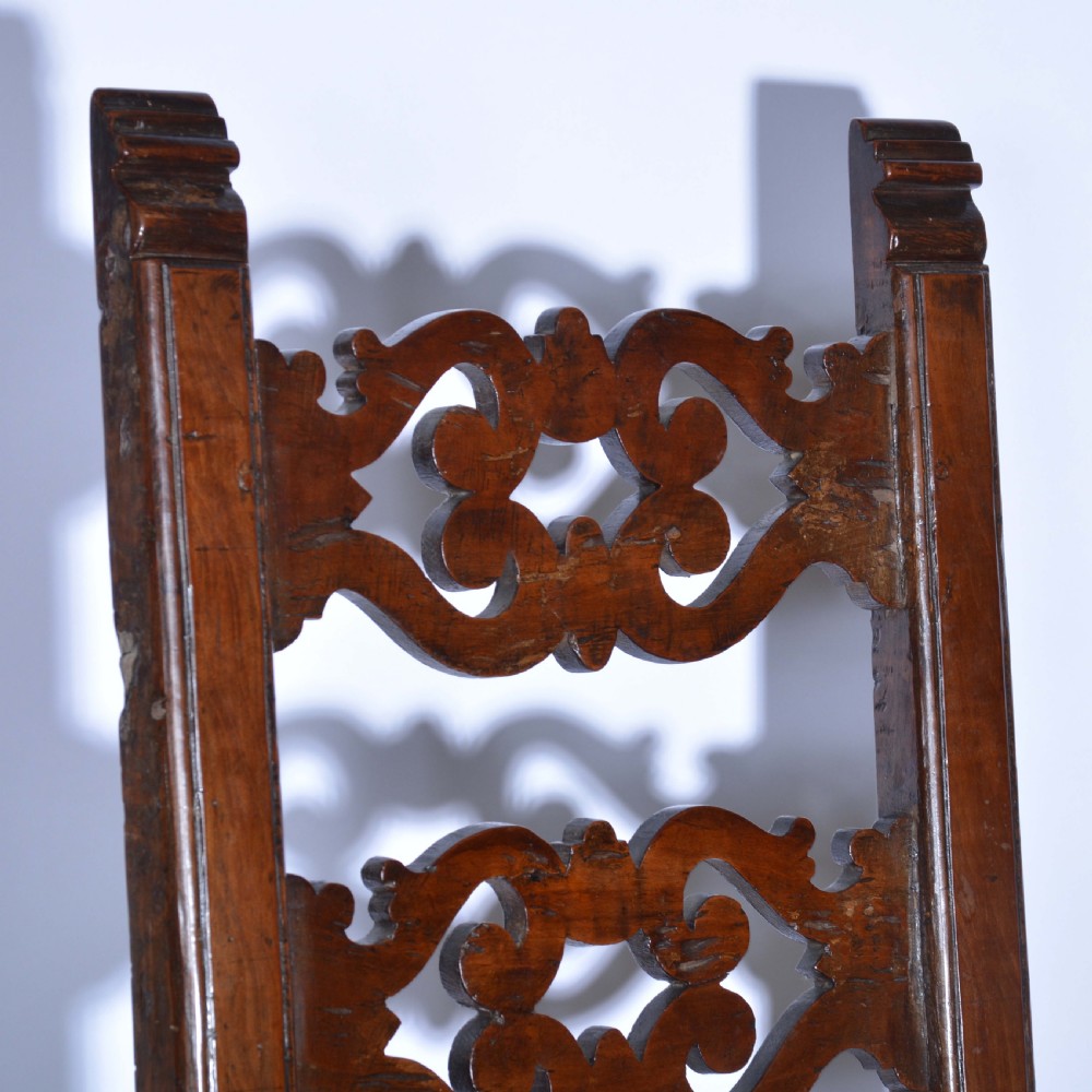 A small Italian country walnut side chair featuring two scroll-carved back splats, a woven rush seat, and sturdy square legs. View III