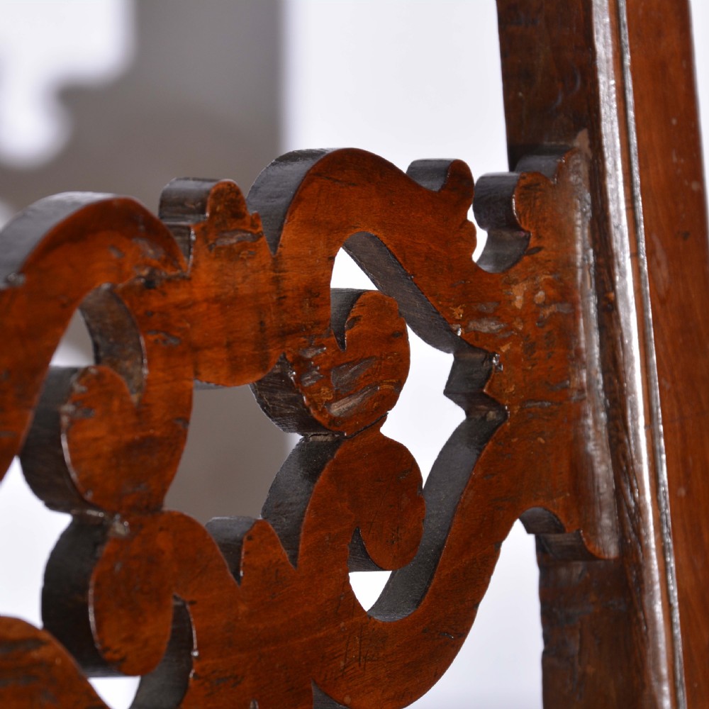 A small Italian country walnut side chair featuring two scroll-carved back splats, a woven rush seat, and sturdy square legs. View IV