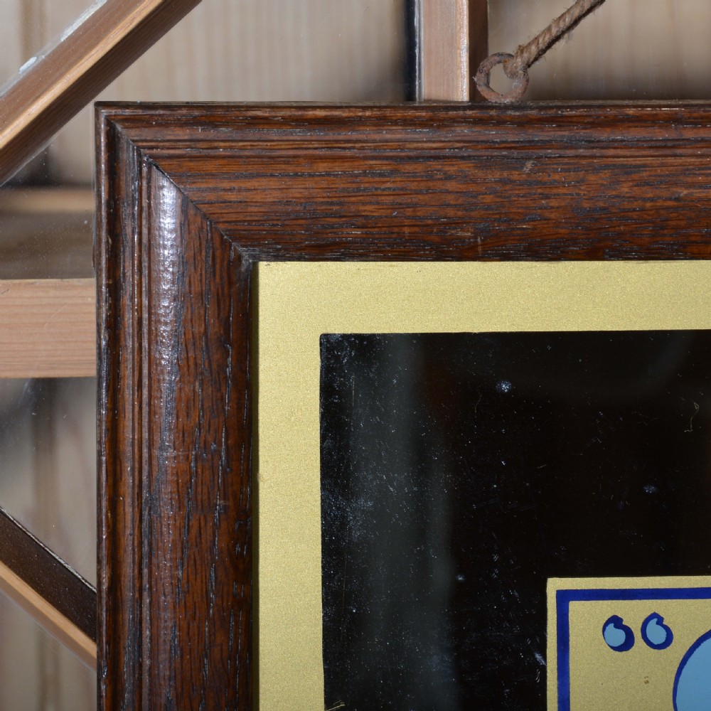 A framed rectangular antique advertising mirror featuring Capstan Navy Cut Cigarettes lettering in blue and gold on a dark background. View II