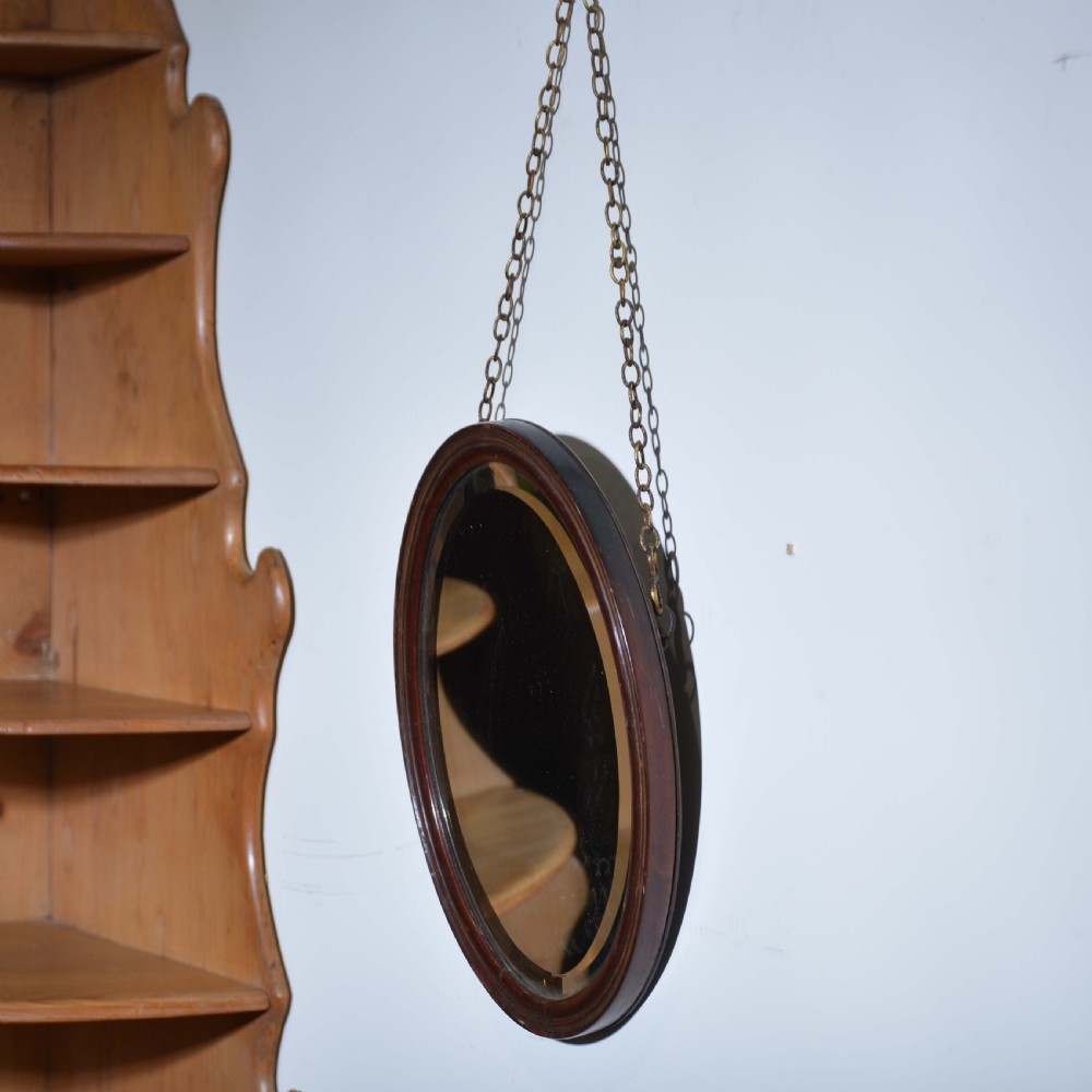 Small red lacquered oval mirror with bevelled edge View II