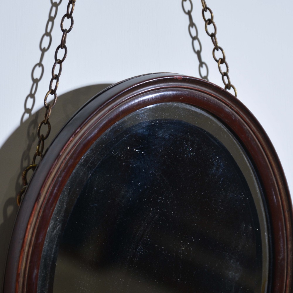 Small red lacquered oval mirror with bevelled edge View III