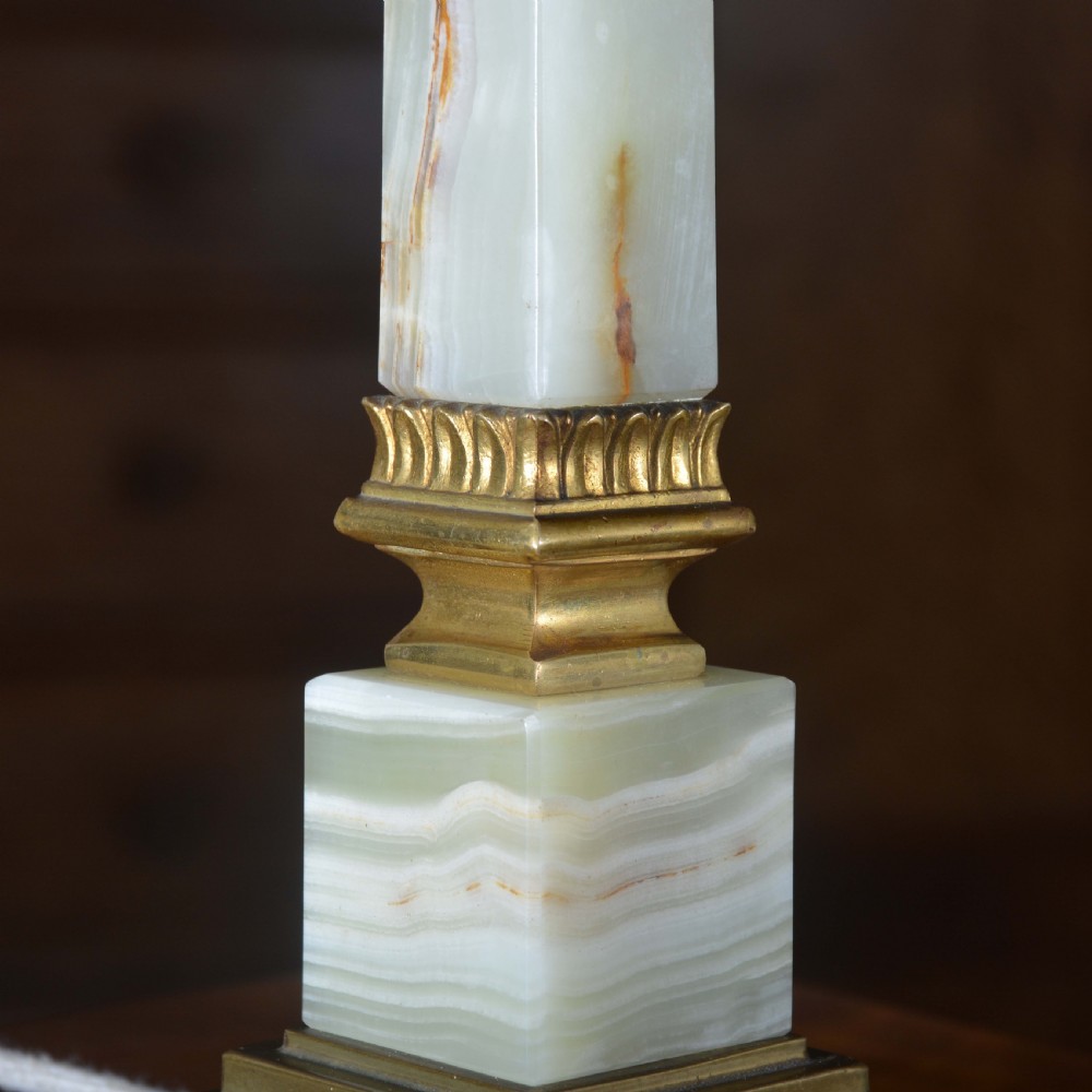 A tapered pale green onyx column table lamp featuring gilt brass collar details and a black fabric lamp shade. View VI
