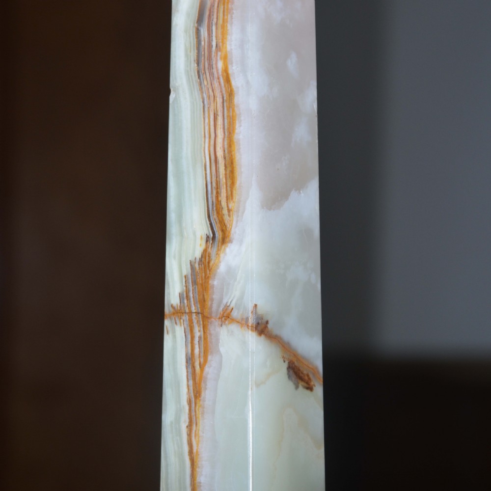 A tapered pale green onyx column table lamp featuring gilt brass collar details and a black fabric lamp shade. View VII