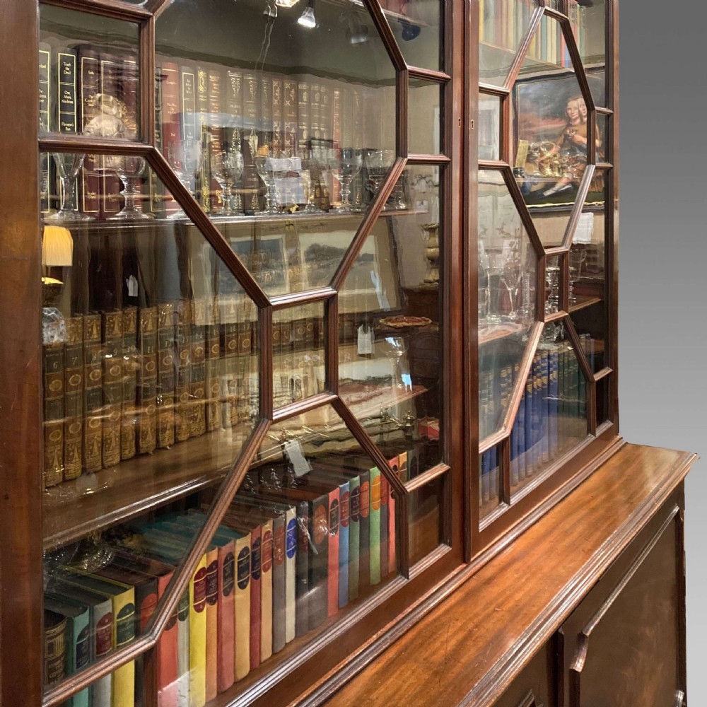 A tall Georgian mahogany bookcase with two astragal glazed upper doors and a panelled twin-door base. View II