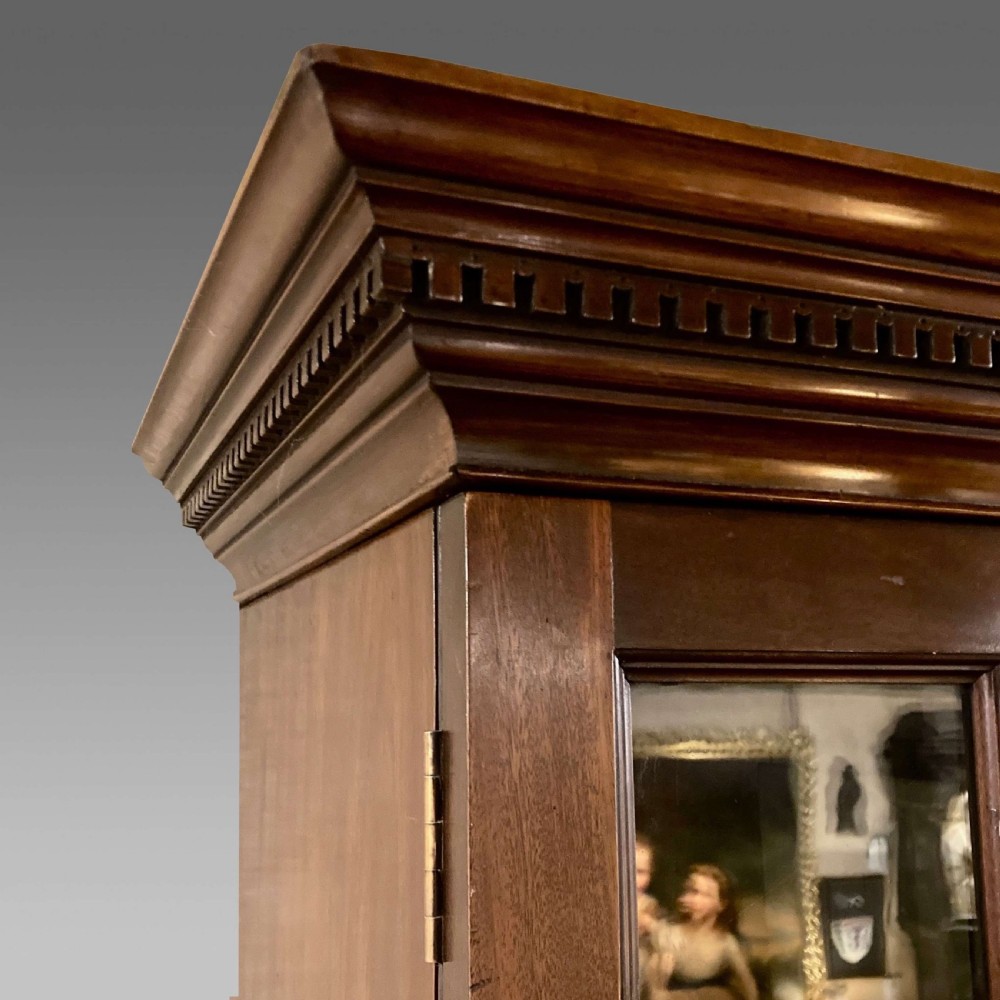 A tall Georgian mahogany bookcase with two astragal glazed upper doors and a panelled twin-door base. View III
