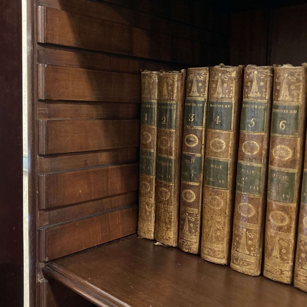 A tall Georgian mahogany bookcase with two astragal glazed upper doors and a panelled twin-door base. View VI