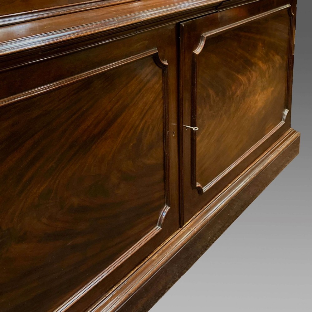 A tall Georgian mahogany bookcase with two astragal glazed upper doors and a panelled twin-door base. View VIII