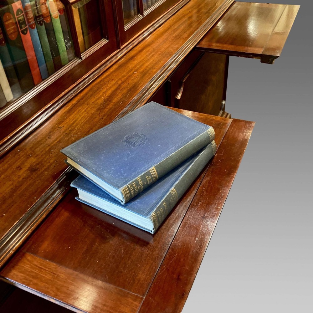 A tall Georgian mahogany bookcase with two astragal glazed upper doors and a panelled twin-door base. View X