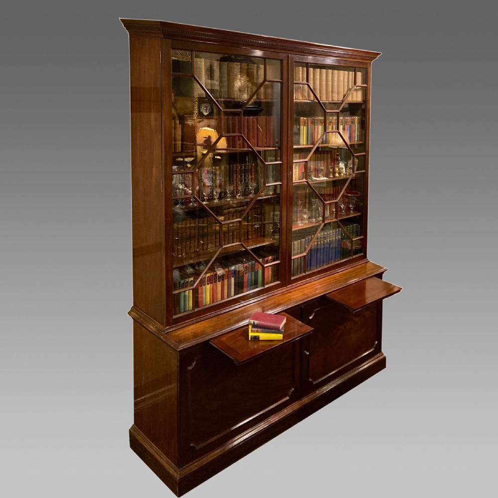 A tall Georgian mahogany bookcase with two astragal glazed upper doors and a panelled twin-door base. View XII