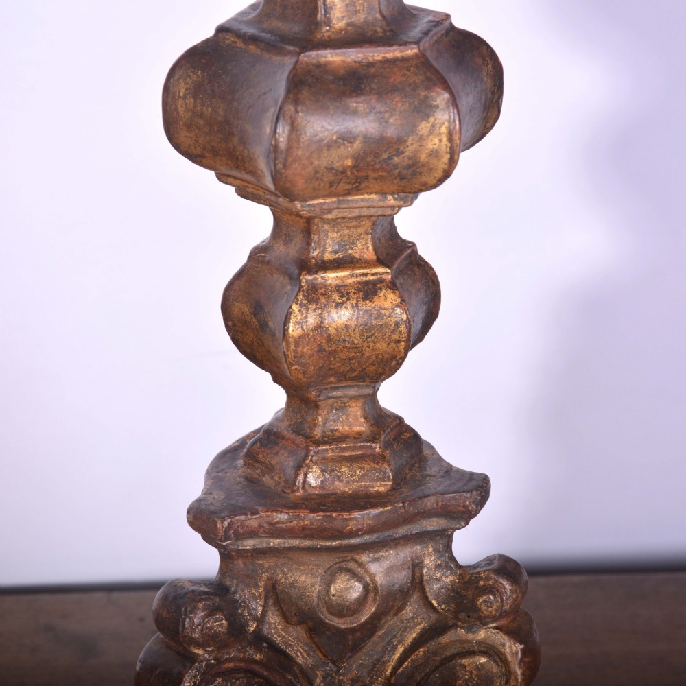 A tall Spanish gilt wood table lamp featuring a turned, carved column base finished in gold leaf, paired with a black flared lampshade. View III