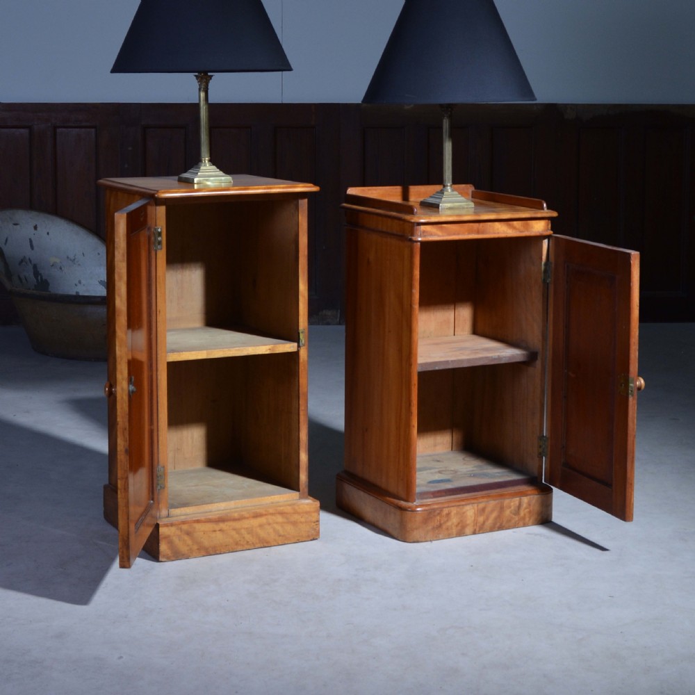 A near pair of Victorian satin birch bedside cabinets featuring single panelled doors, turned timber knobs, and plinth bases. View VII