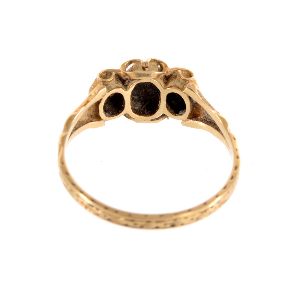 A Victorian yellow gold ring set with three oval cabochon turquoise gemstones featuring scrollwork shoulders. View IV