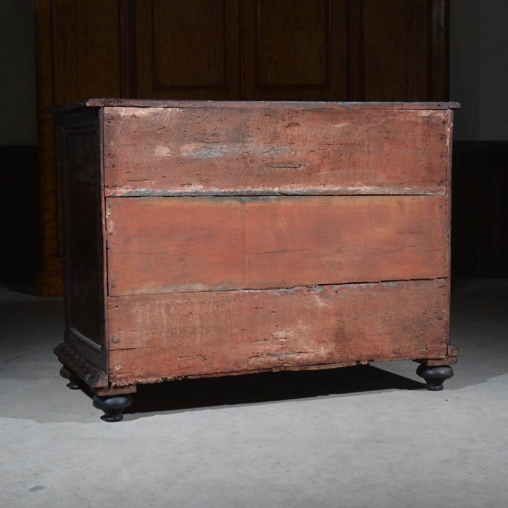 A dark carved walnut Italian Renaissance style chest of drawers featuring small carved figural pilasters and turned bun feet. View XIX