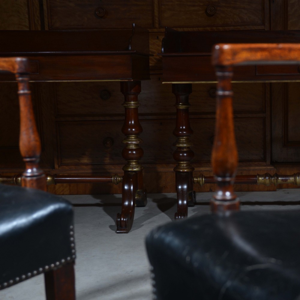 A matched pair of mahogany dressing tables featuring raised gallery tops, single frieze drawers, and turned legs with brass-collared stretchers. View II