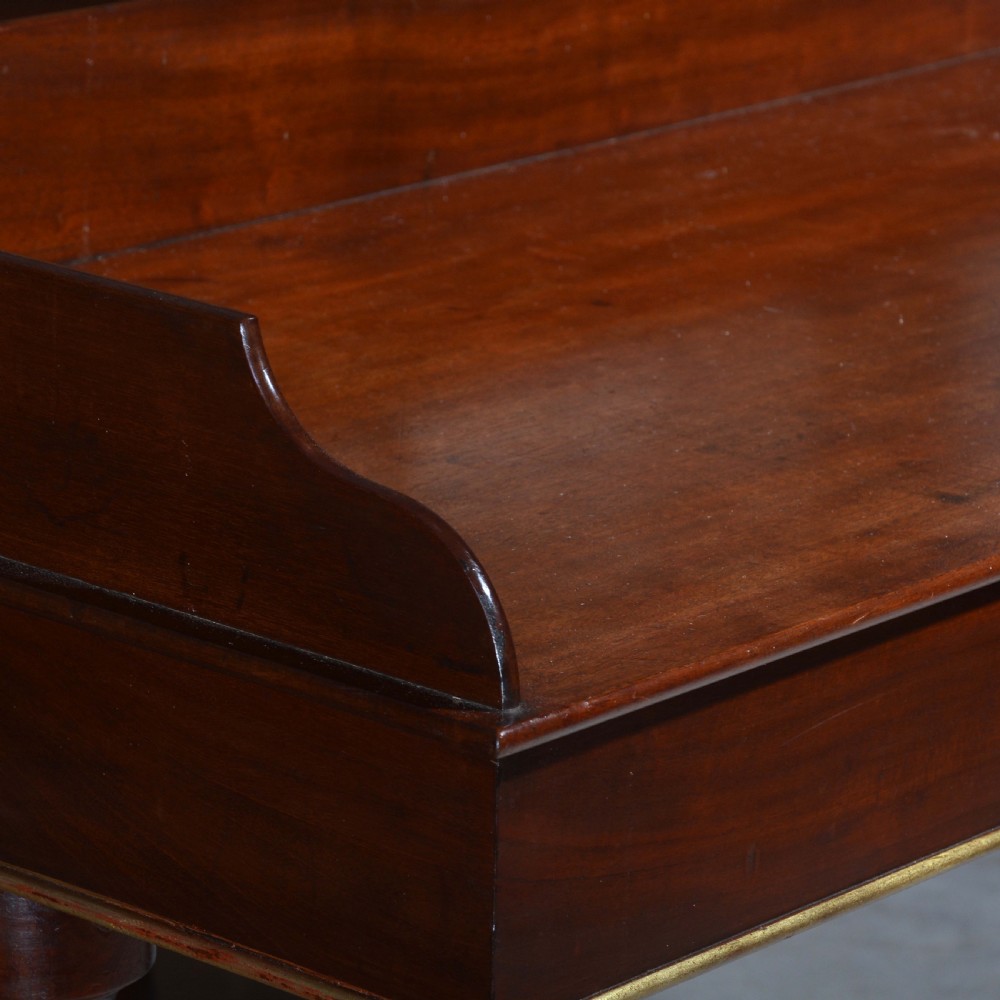 A matched pair of mahogany dressing tables featuring raised gallery tops, single frieze drawers, and turned legs with brass-collared stretchers. View III