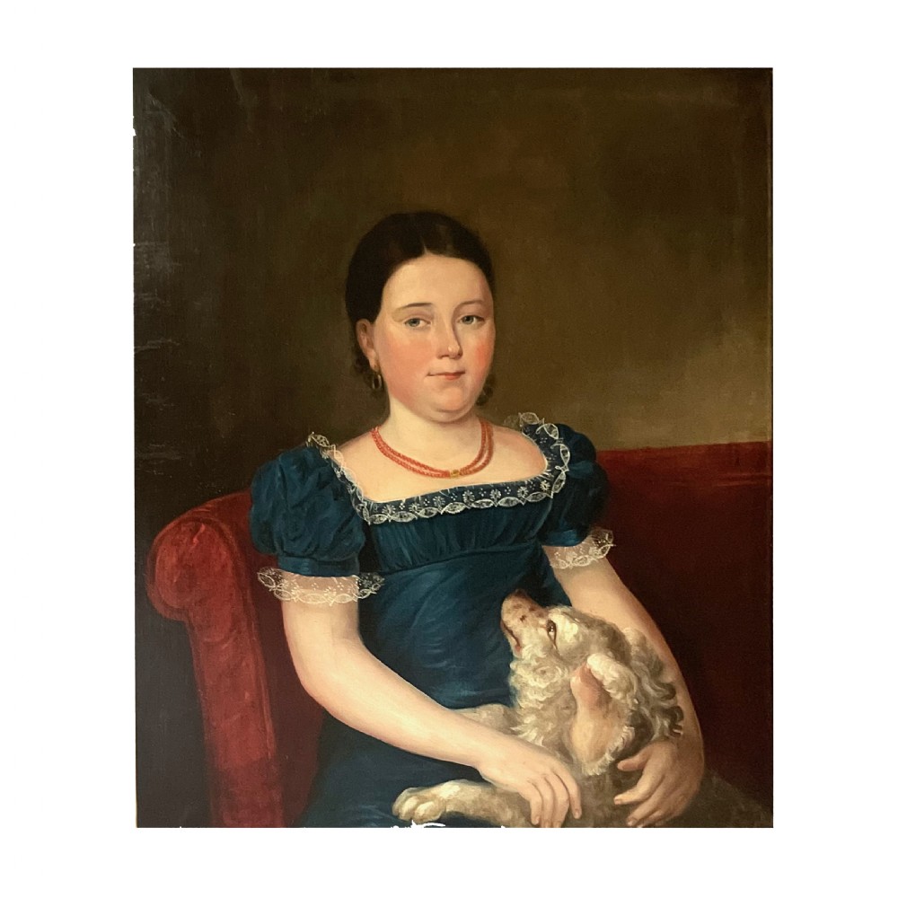 An antique folk art oil painting depicting a seated young girl in a blue lace-trimmed dress holding a small dog in her lap.