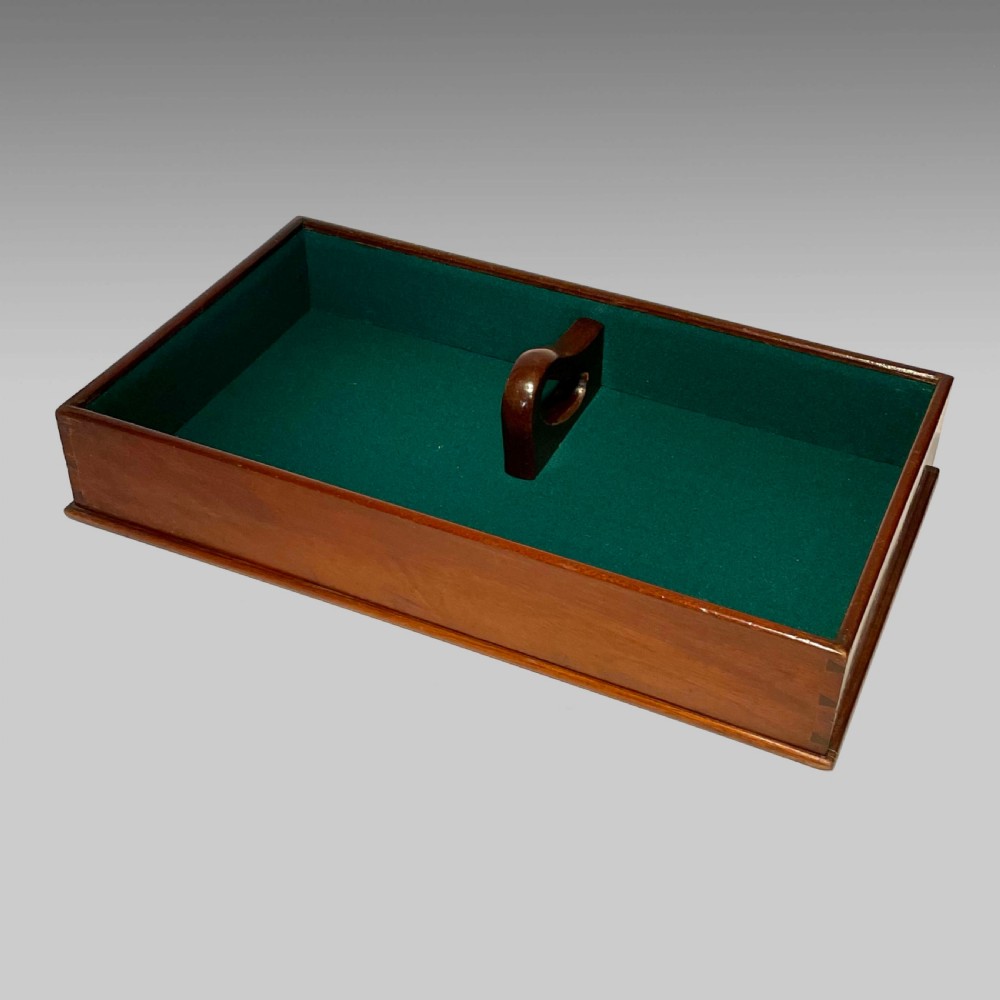 A rectangular Georgian mahogany tray lined with green baize fabric featuring a central cutout carrying handle and hand-cut dovetail joints.
