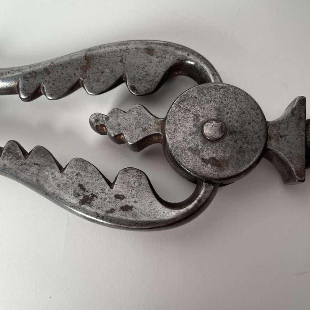 A set of three Georgian fire irons featuring steel shafts and ornate gilt brass foliate handles including a pierced shovel, tongs, and poker. View III