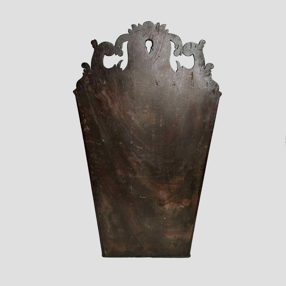 A Georgian mahogany wall-hanging cutlery box with a sloped lid, brass stud details, and a carved pierced crest. View V