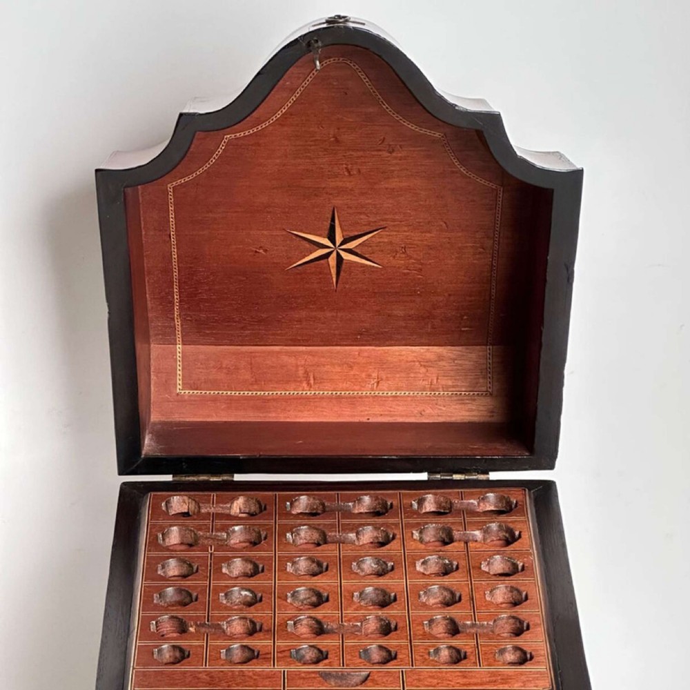 An antique Sheraton mahogany knife box featuring a sloped lid, serpentine shaped front, and a brass keyhole escutcheon. View IV