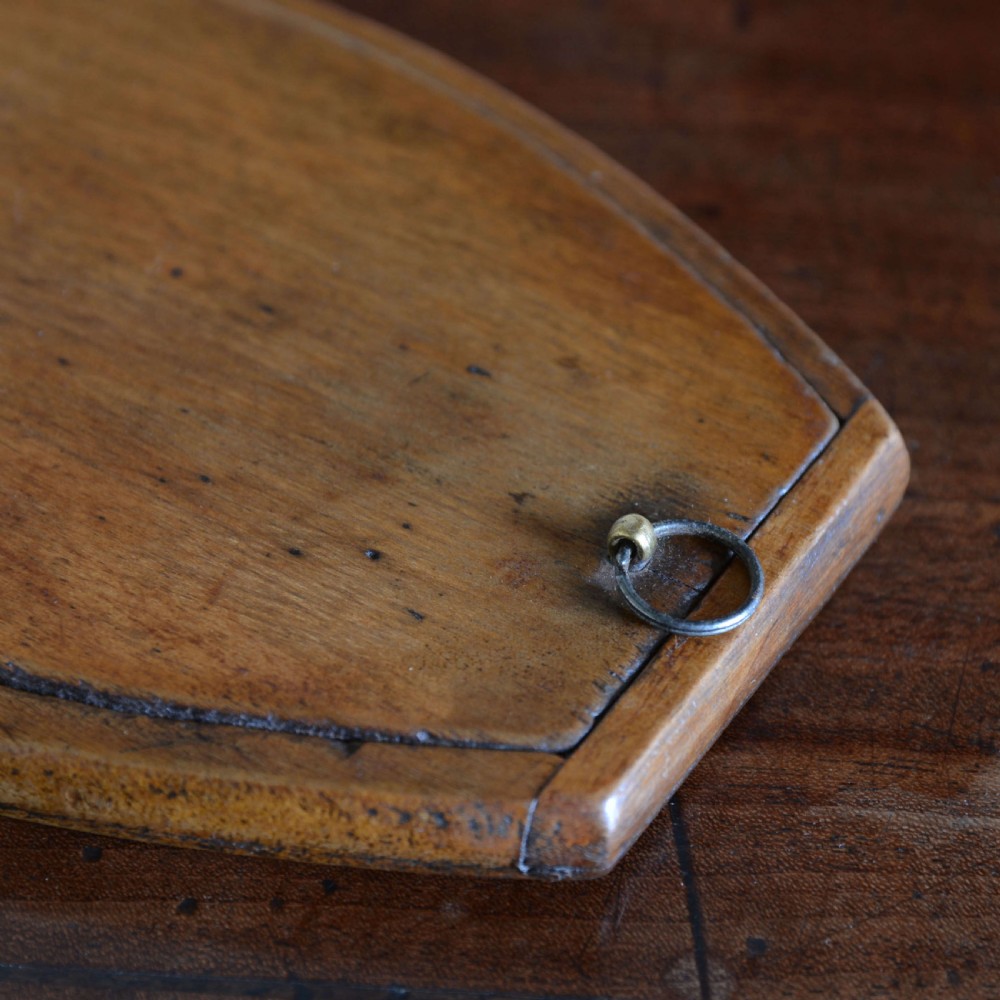 A hinged walnut campaign shaving mirror with an oval glass plate resting open on a wooden surface. View VIII