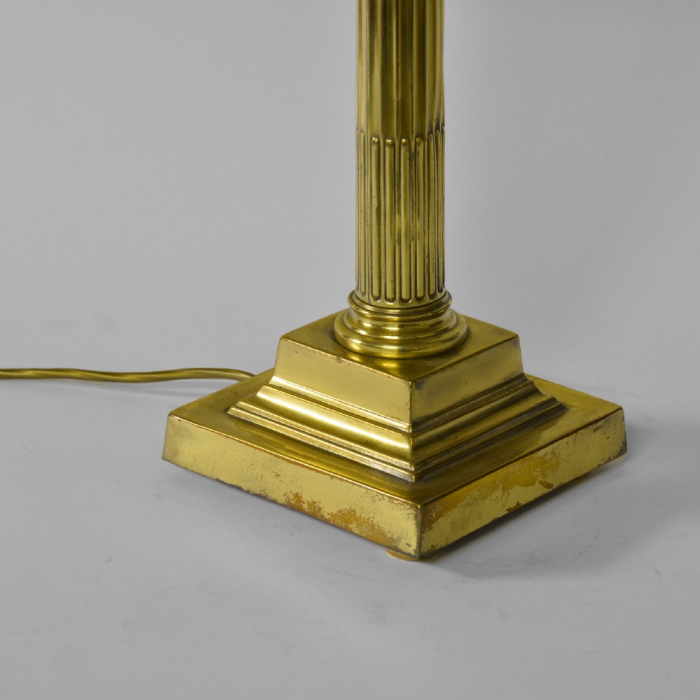 A Victorian cast brass table lamp featuring a fluted Corinthian column shaft topped with acanthus leaves on a stepped plinth. View II
